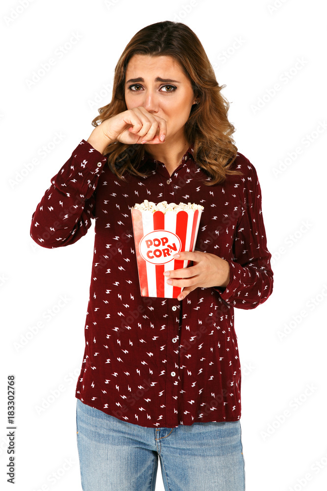Casual woman crying while holding popcorn Casual woman crying while holding popcorn
