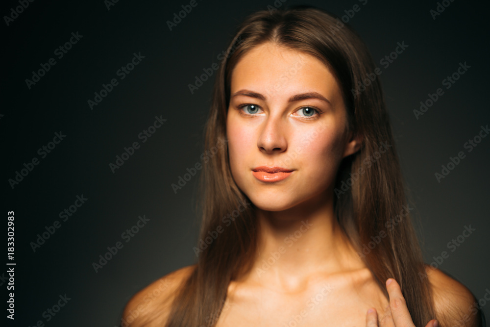 Portrait beautiful girl on a dark studio background Portrait beautiful girl on a dark studio background