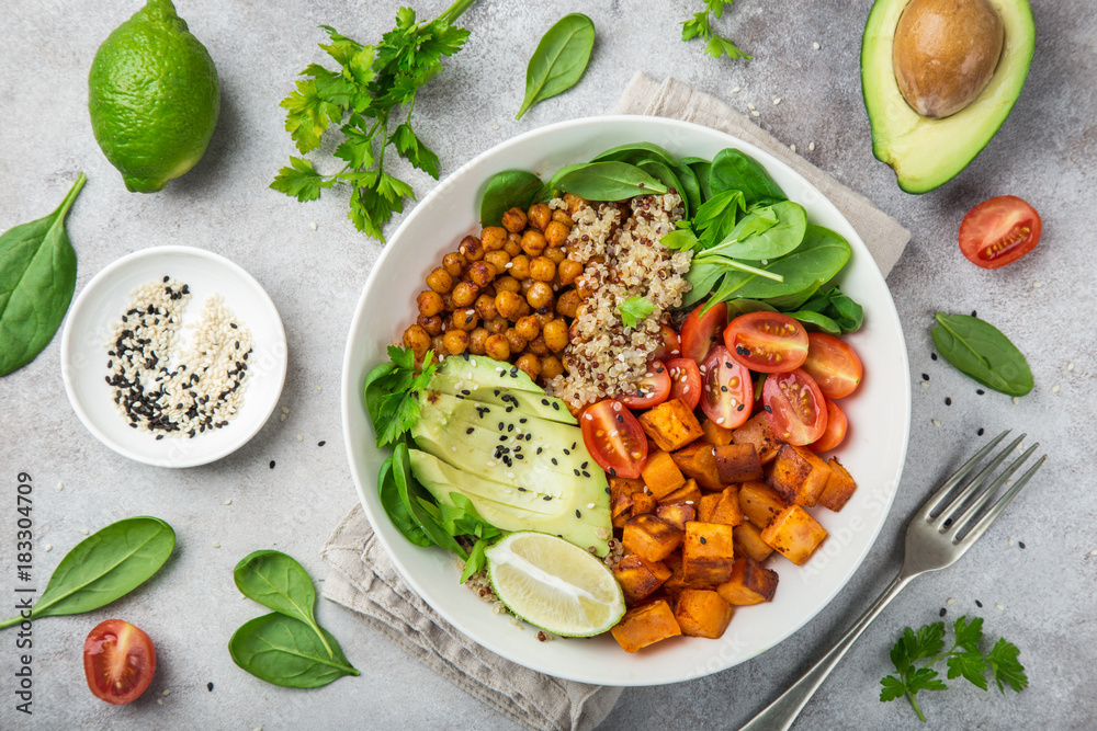 healhty vegan lunch bowl. Avocado, quinoa, sweet potato, tomato, spinach and chickpeas vegetables salad - obrazy, fototapety, plakaty 