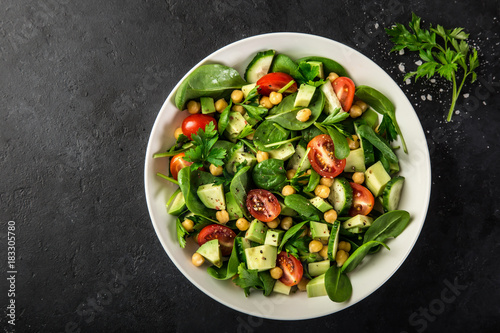 Avocado, tomato, chickpeas, spinach and cucumber salad