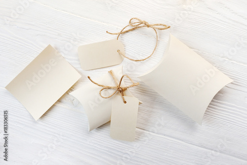 Mockup letter, boxes of bonbonniere and tag with place for your text on a white wooden background