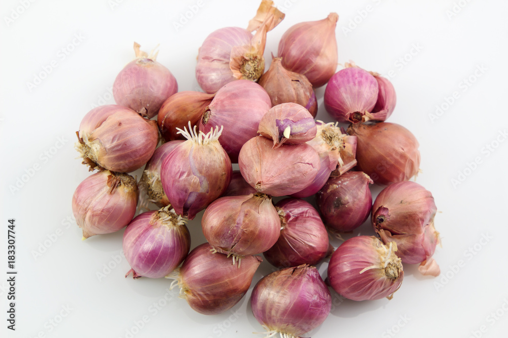Pile of red onions with root on white background, Thai onions.