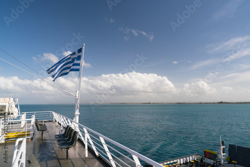Ferry boat in Greece view on sea and national flag