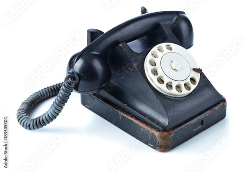 Old black phone isolated on white.