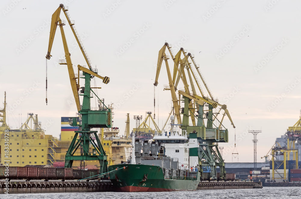 Cargo freight ship and cargo container working with crane at port area,Logistic Import Export.