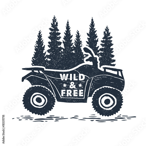 Hand drawn inspirational label with pine trees and quad bike textured vector illustrations and "Wild and free" lettering.