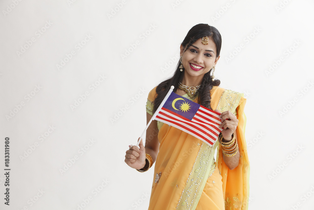 Indian woman in traditional clothing holding flag Indian woman in traditional clothing holding flag