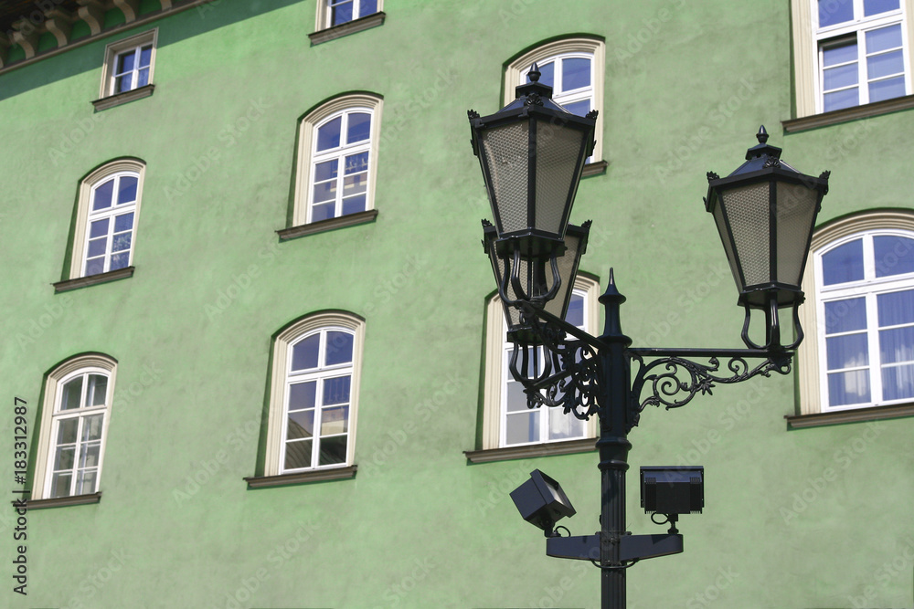 Street lamp in front of green-wall windows Street lamp in front of green-wall windows