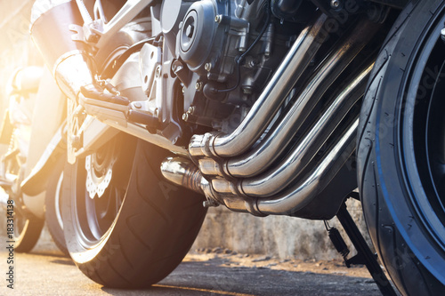 Modern motorcycle and exhaust details parking on street background © ipopba