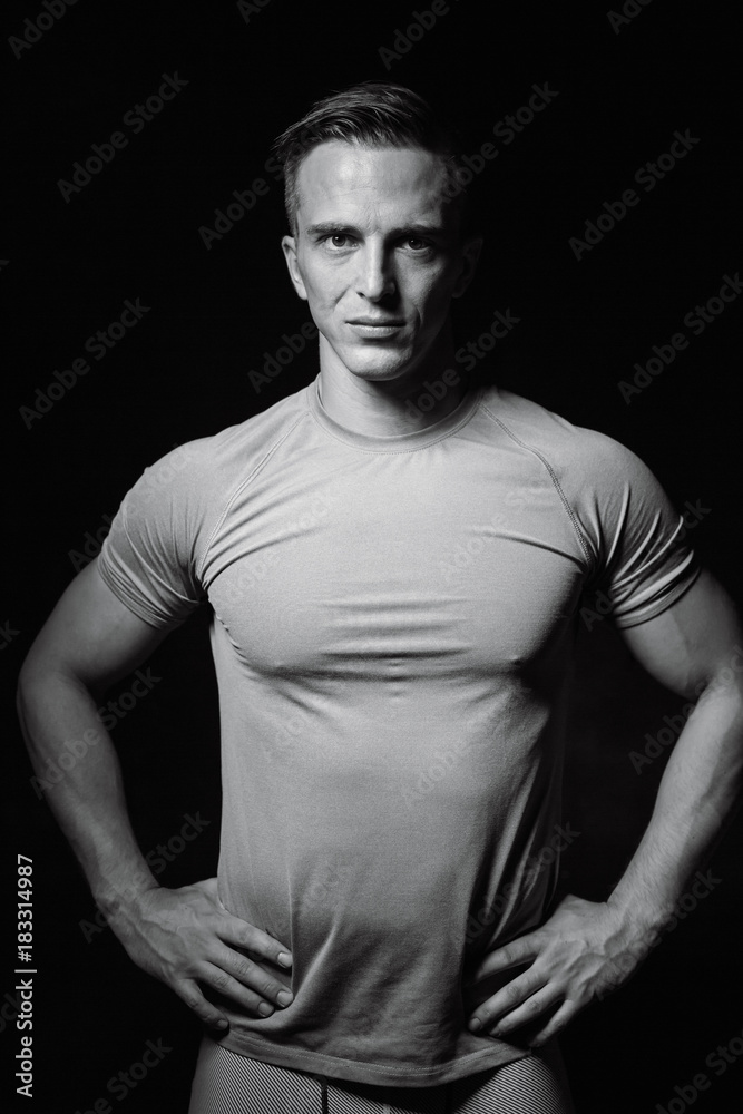 Portrait of bodybuilder shoor in studio on black background