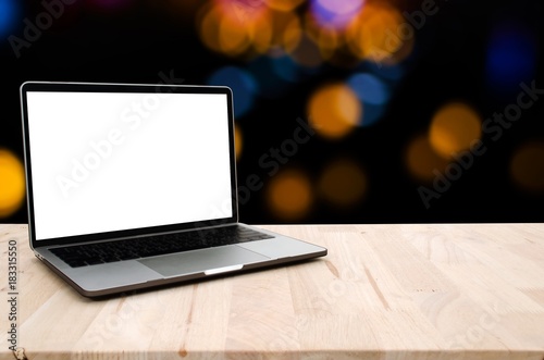 laptop notebook computer with white blank screen on desk with bokeh light at night background, advertisement, workspace, internet technology, online social media, searching data concept