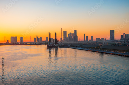 Abu Dhabi port and skyline at sunset.