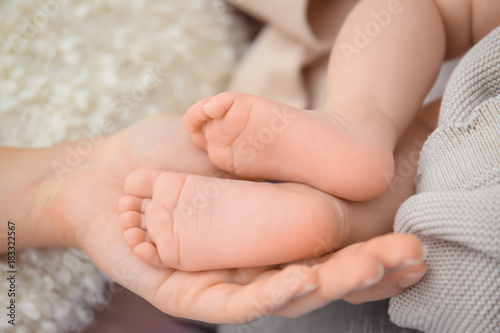 Mother holding baby feet, closeup