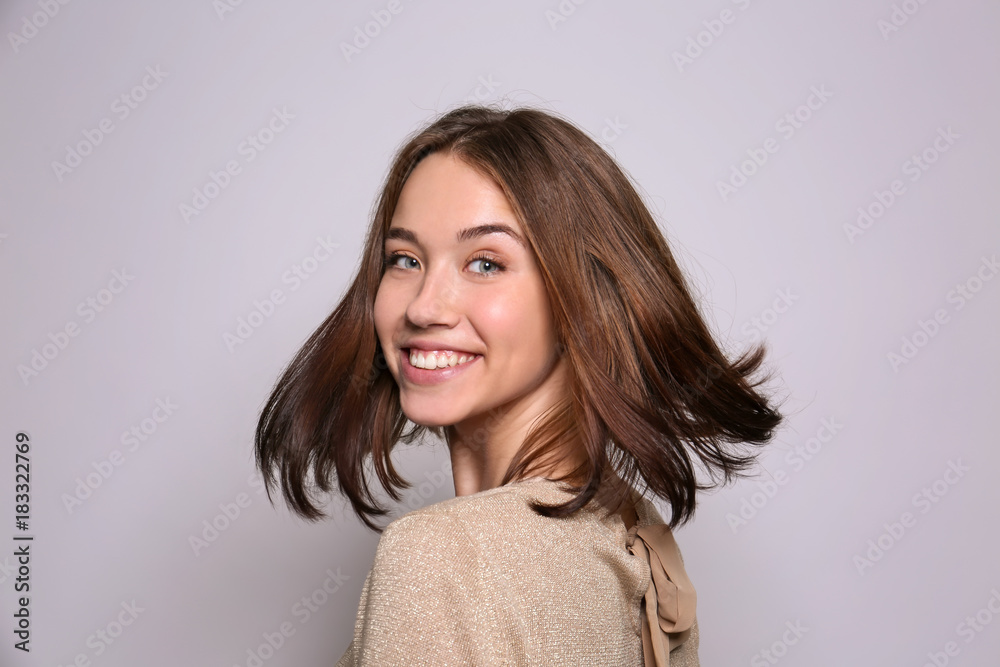 Beautiful smiling woman on light background Beautiful smiling woman on light background