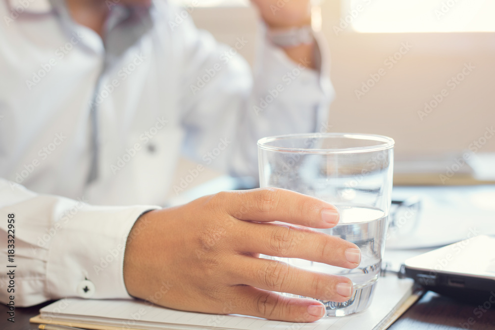 businessman holding glass of drinking water. businessman holding glass of drinking water.