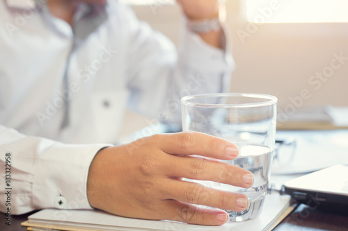 businessman holding glass of drinking water.