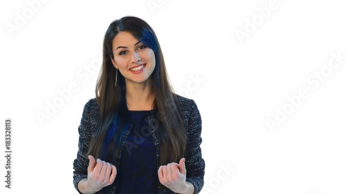Closeup of young brunette woman looking at camera talking and gesticulating, over white background