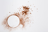 Circle of cocoa powder on white table