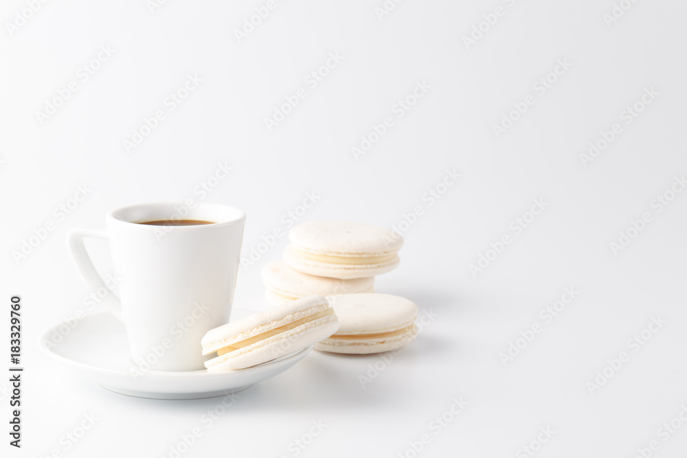 Minimalistic shot of espresso cup with one white macaroon Minimalistic shot of espresso cup with one white macaroon