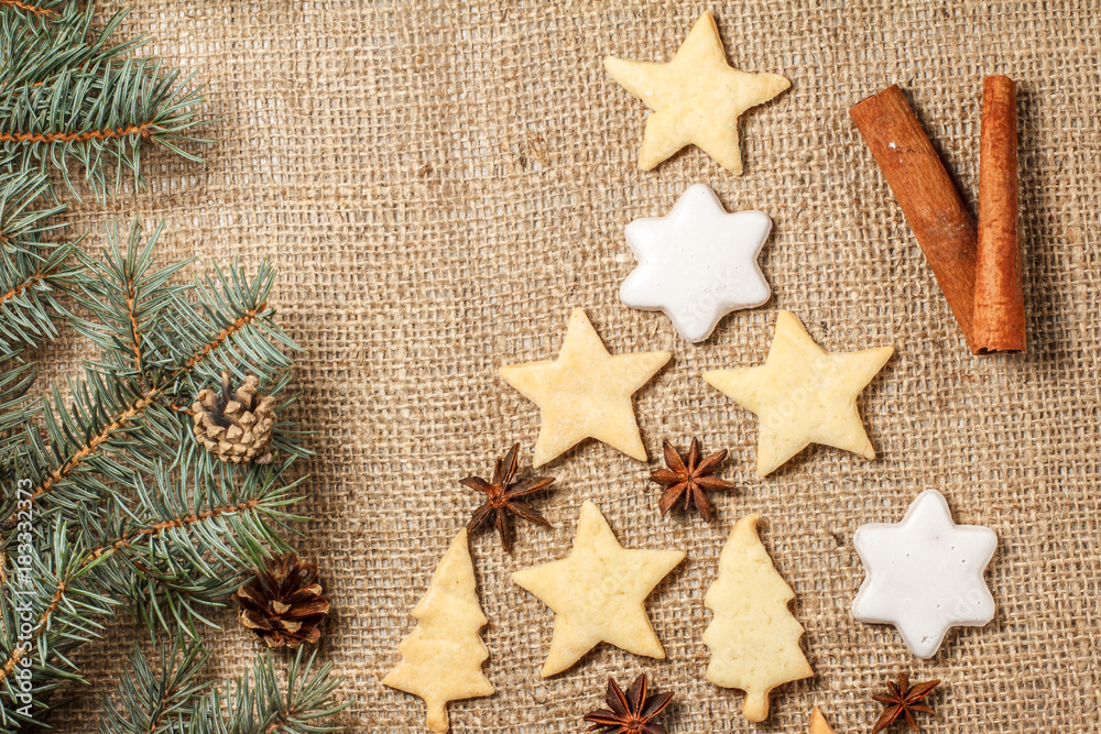 Fototapeta premium Gingerbread cookies in Christmas tree and star shape on sackcloth