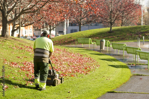 lawn mower grass service gardener in city park