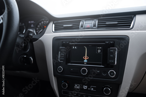 Car navigation system in modern car interior.