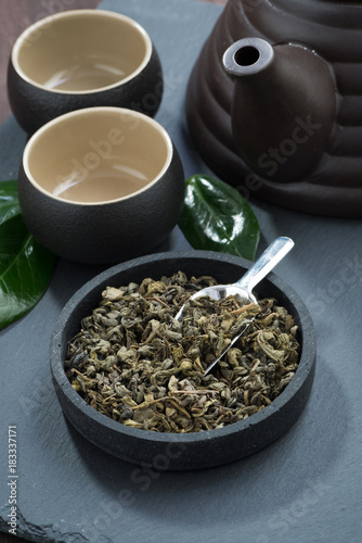 green tea in a ceramic bowl and tea utensils