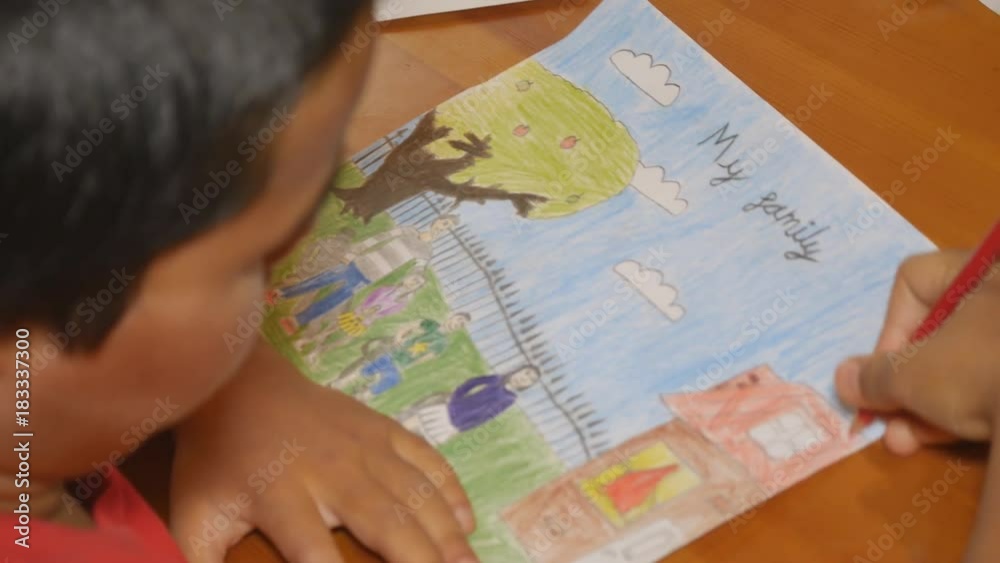 The boy draws his family. The boy draws his family.