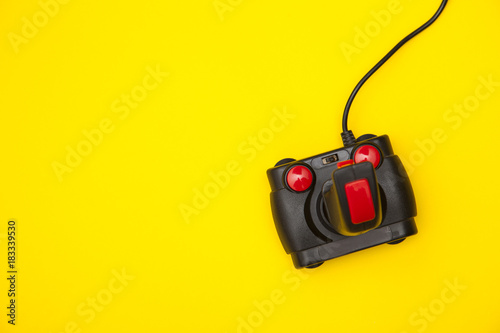 Retro computer gaming controller on a bright yellow background
