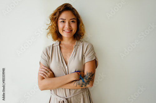 Positive Asian woman looking at camera and smiling