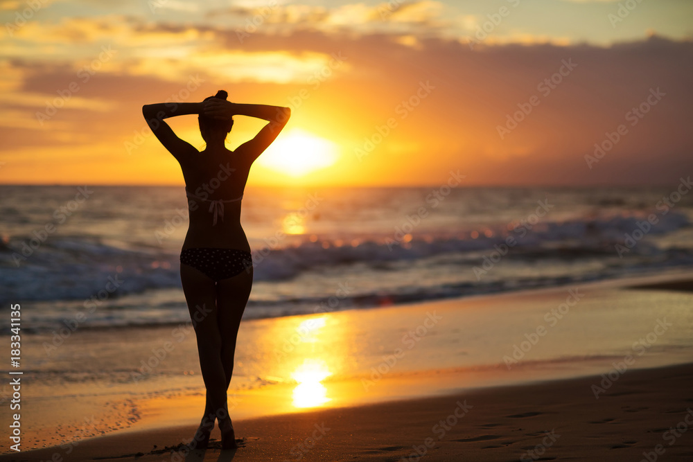 Young beautiful woman has fun at the ocean in summertime
