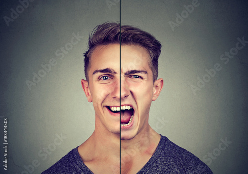 Bipolar disorder concept. Young man with double face expression isolated on gray background photo