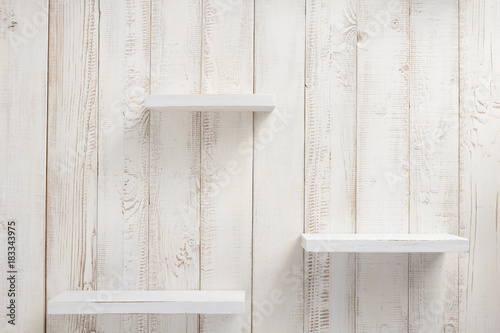 set of wooden shelves on wall background photo
