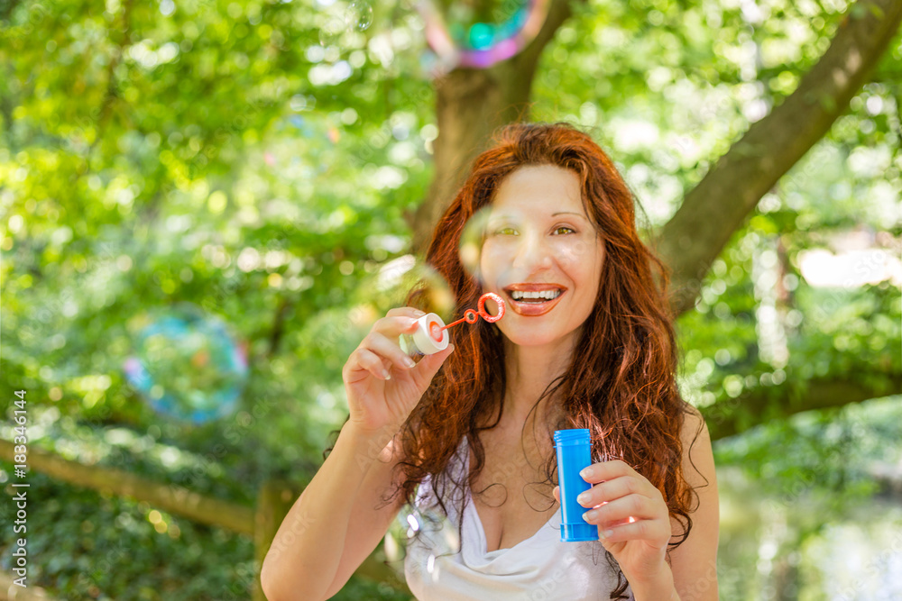 woman having fun with soap bubbles woman having fun with soap bubbles