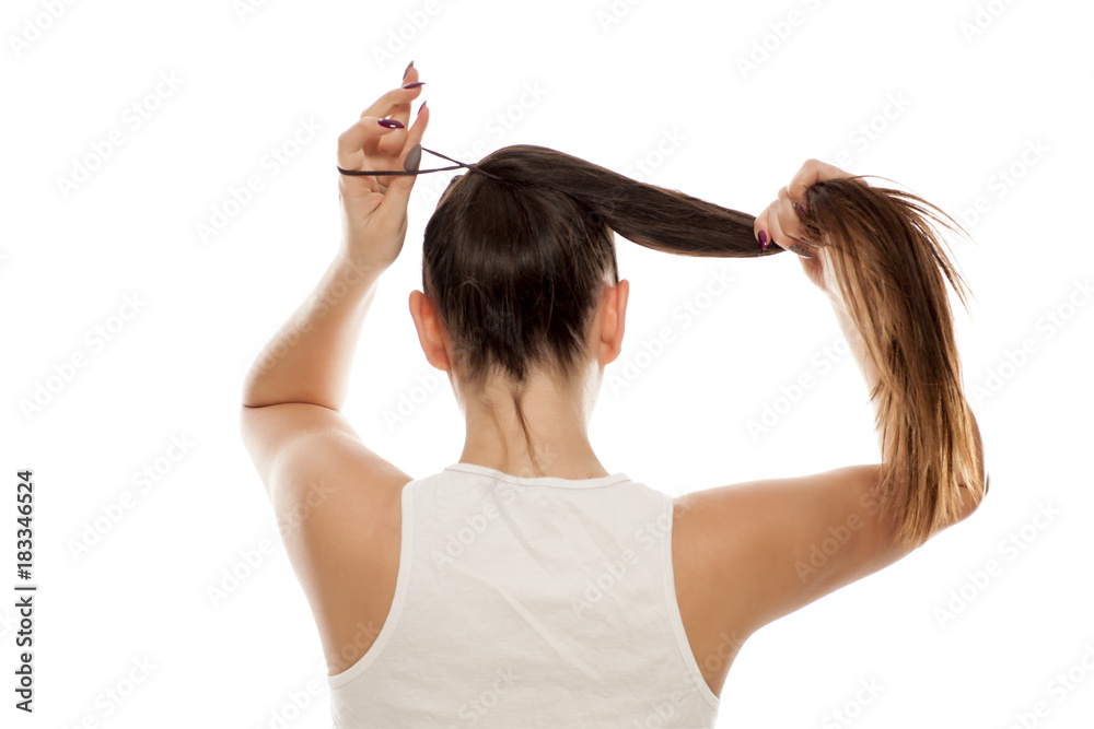 Back view of young woman tied her hair in ponytail Stock Photo | Adobe Stock