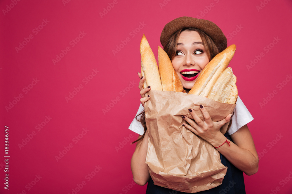 Happy excited lady holding baguetes and smiling to camera Happy excited lady holding baguetes and smiling to camera