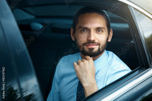 Smiling Business Man In Car. Business People Portrait