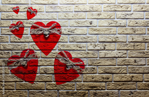 Valentine's day background with red hearts on a brick wall photo