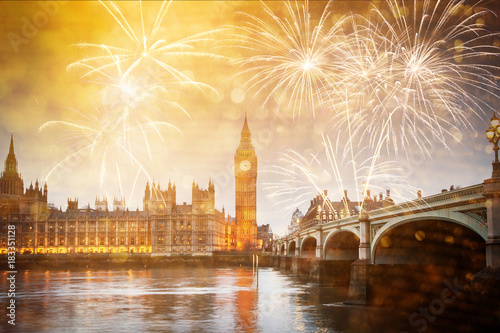 explosive fireworks display fills the sky around Big Ben. New Year's Eve celebration in the city