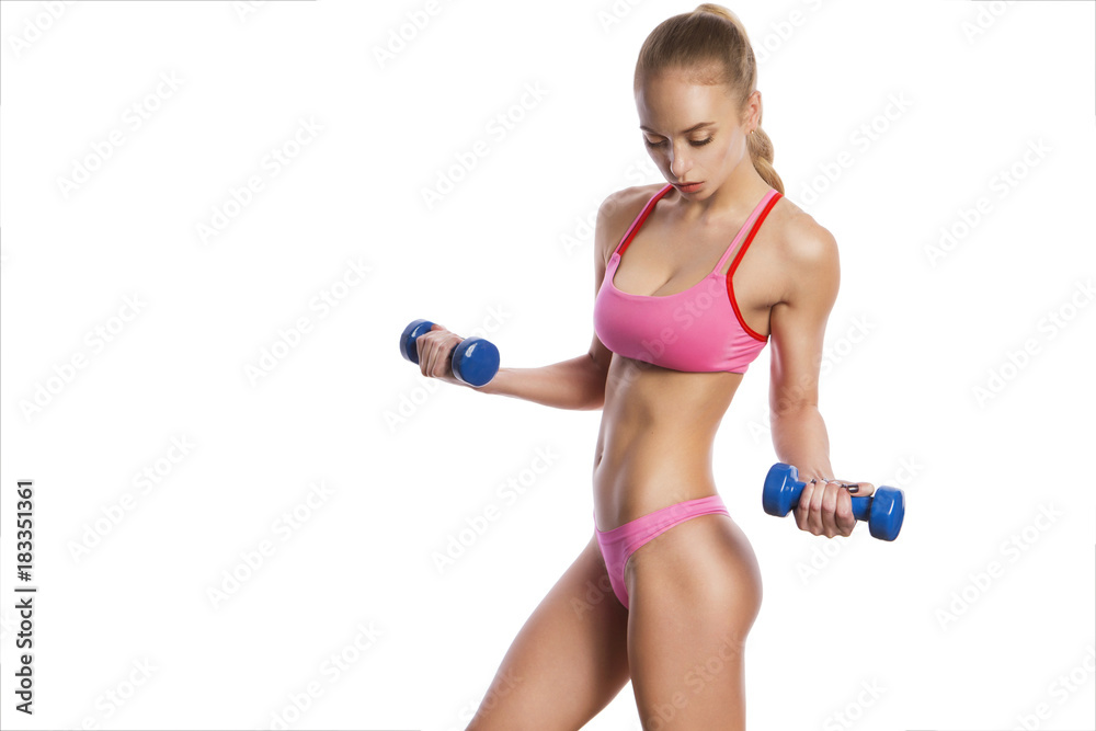 Beautiful brunette caucasian young woman with fit athletic body in sportswear do sport exercise with heavy dumbbell pumping up muscles on her hands. Neutral white isolated background Beautiful brunette caucasian young woman with fit athletic body in sportswear do sport exercise with heavy dumbbell pumping up muscles on her hands. Neutral white isolated background