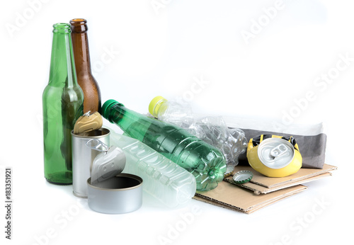 Recyclable garbage consisting of glass, plastic bottle, metal and paper isolated on white background