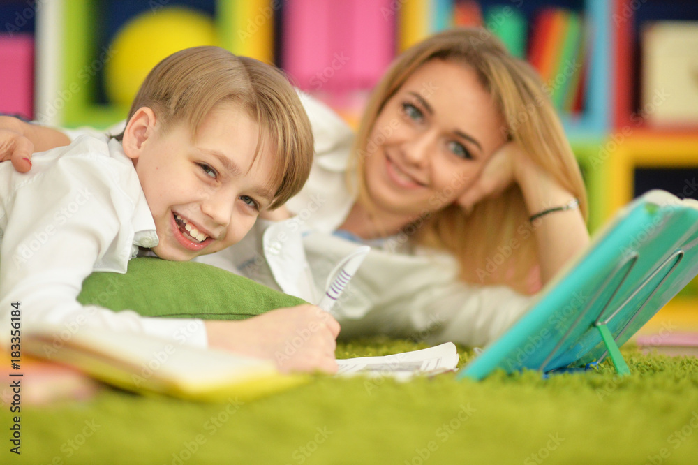 Fototapeta premium Mother with her son doing homework