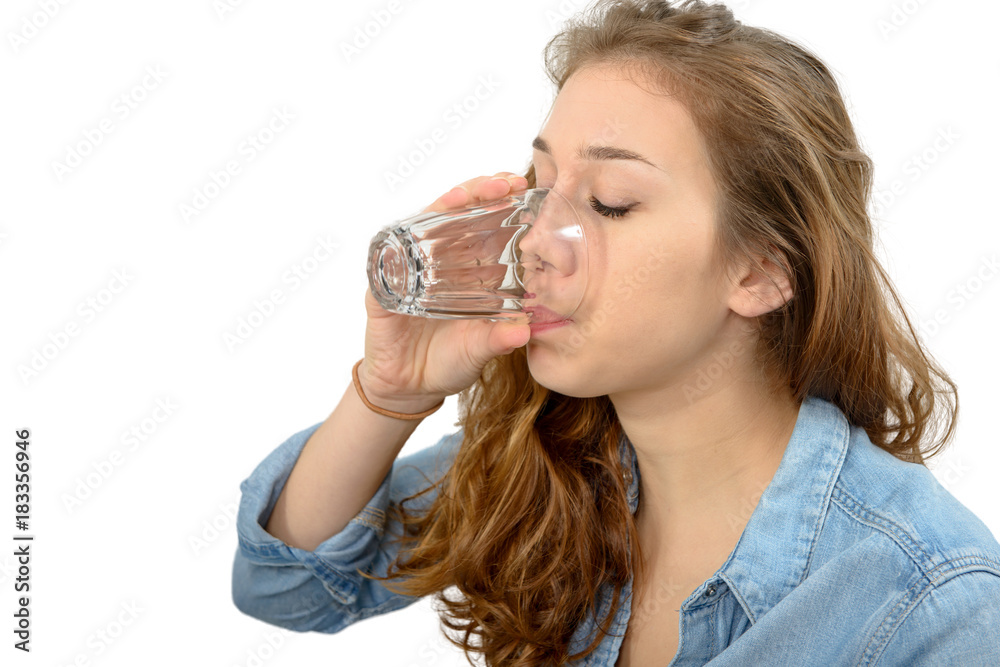 young woman drinking a glass of water, on white young woman drinking a glass of water, on white