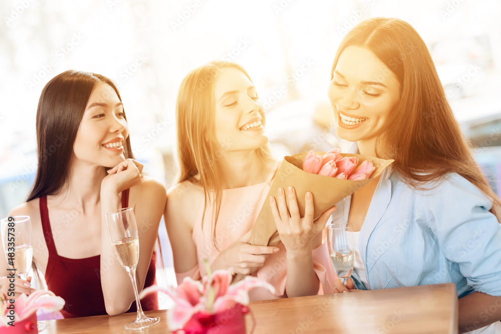 Three girls celebrate the holiday on March 8.