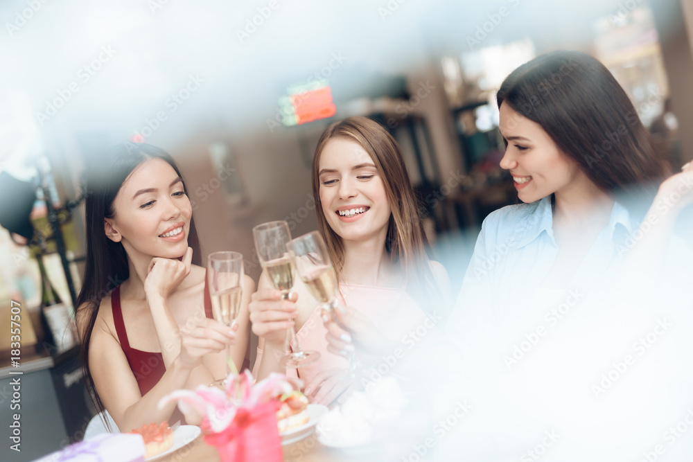 Three girls are sitting together in a cafe. Three girls are sitting together in a cafe.