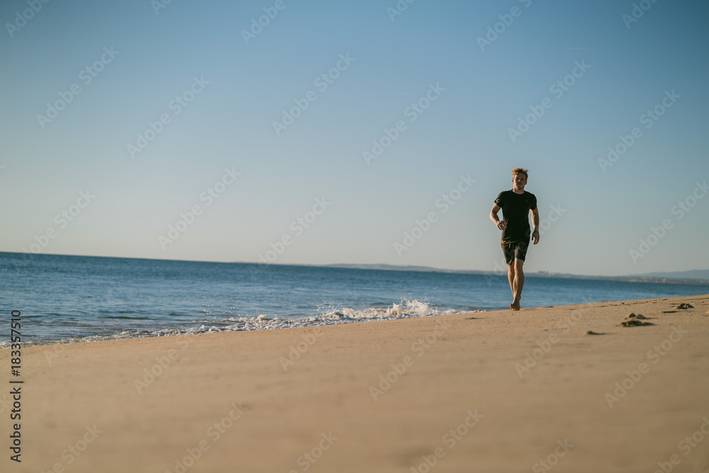 Man running on a beach at sunset in Portugal