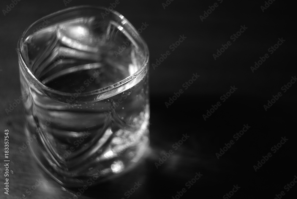 a glass of water on a black background black and white