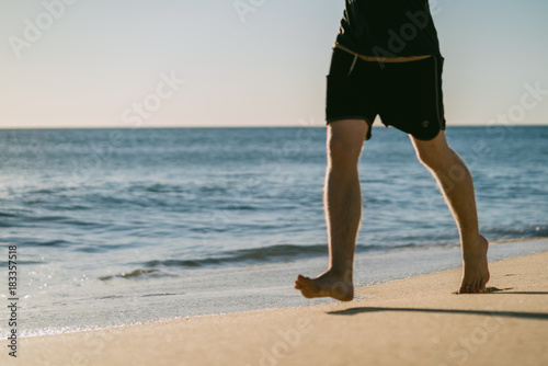 Man running on a beach at sunset in Portugal