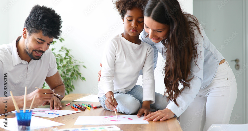 Mom and dad drawing with their daughter. Mom and dad drawing with their daughter.
