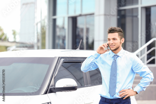 Salesman talking on phone n...